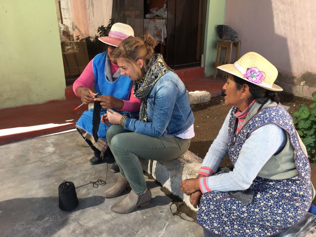 Brianna working with two women in peru